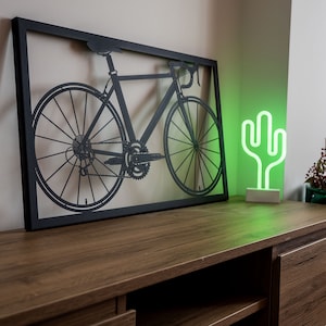 Bike metal wall art, perfect as cycling decor or a thoughtful gift for bike lovers and Peloton members. Highlights a passion for cycling in a sleek, artistic form.