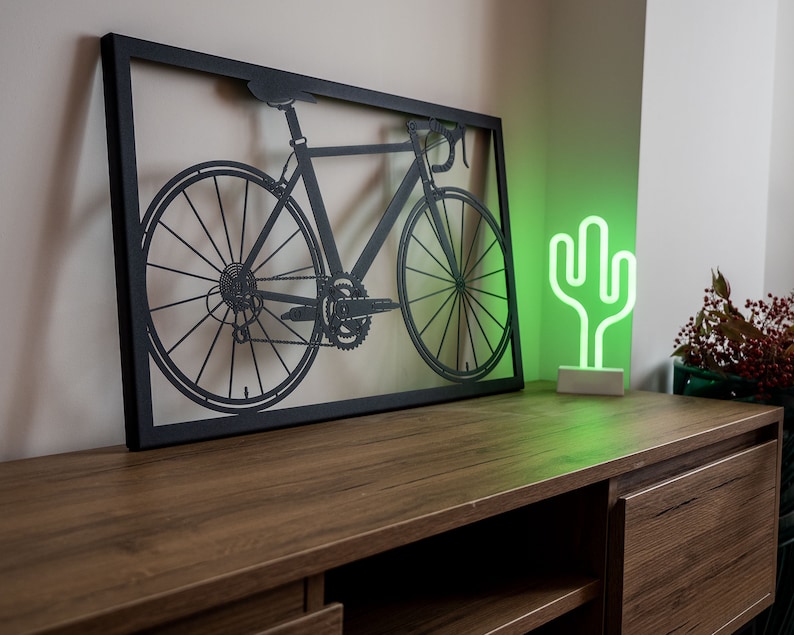 Bike metal wall art, perfect as cycling decor or a thoughtful gift for bike lovers and Peloton members. Highlights a passion for cycling in a sleek, artistic form.