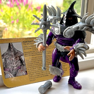 1991 Super Shredder Teenage Mutant Ninja Turtles action figure near complete with stat card