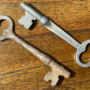2 Authentic Vintage Embossed/Stamped Skeleton Keys