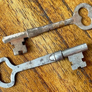 2 Authentic Vintage Embossed/Stamped Skeleton Keys
