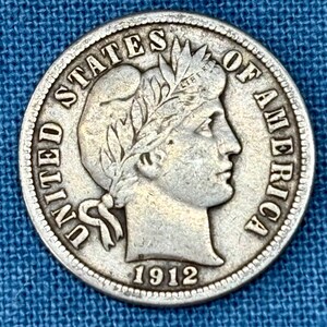 May include: A set of three ceramic mugs with a speckled, matte finish. The mugs are in shades of cream, light gray, and dark gray. Each mug has a simple, minimalist design and a rounded handle.