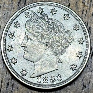 1883 Liberty V Nickel “No Cents” in AU-UNC condition, perfect rim, stars, corn and hair detail