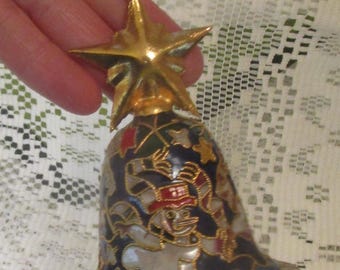 May include: A Christmas bell ornament with a gold star topper and a red ribbon. The bell features a snowman design with gold accents on a navy blue background. The ornament is approximately 3 inches tall.
