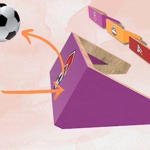 May include: A purple and wood soccer goal with a black and white rocket design. The goal is angled and a soccer ball is flying towards it.