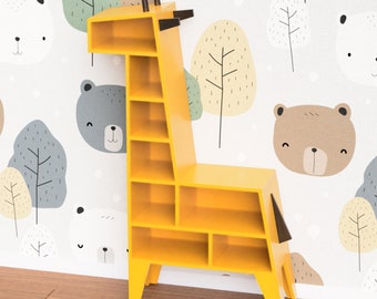 May include: A yellow giraffe-shaped bookshelf with multiple shelves. The bookshelf is standing on a wooden floor in front of a white wall with a repeating pattern of trees and animal faces.