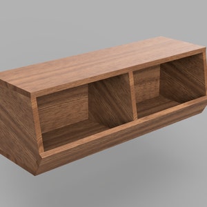 Op de afbeelding: Een houten wandplank met drie schuine compartimenten. De plank is gemaakt van donkerbruin hout en heeft een natuurlijke houtlook.