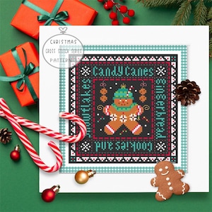May include: Cross stitch pattern featuring a gingerbread person with candy canes, snowflakes, and the text "Cookies and Candy Canes & Gingerbread".