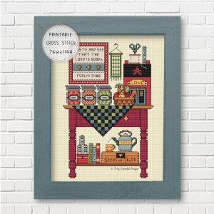 May include: A framed cross-stitch design featuring a red table with jars, a teapot, and the text "Seeds of Ruth." The design includes the text "Taste and See That the Lord is Good" and "Psalm 34:8." The frame is a muted blue.