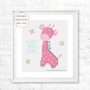May include: A framed cross-stitch art piece featuring a pink giraffe with a smiling face and colorful accents. The text "Sweet Baby Girl" is displayed in turquoise. The artwork measures 50W x 57H.