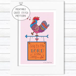 May include: A framed cross-stitch pattern showing a vibrant rooster on a weather vane. The rooster is singing, with musical notes above. The sign below reads "Sing to the LORD a new Song". The words "Printable Cross Stitch Pattern" are in a circle at the top.