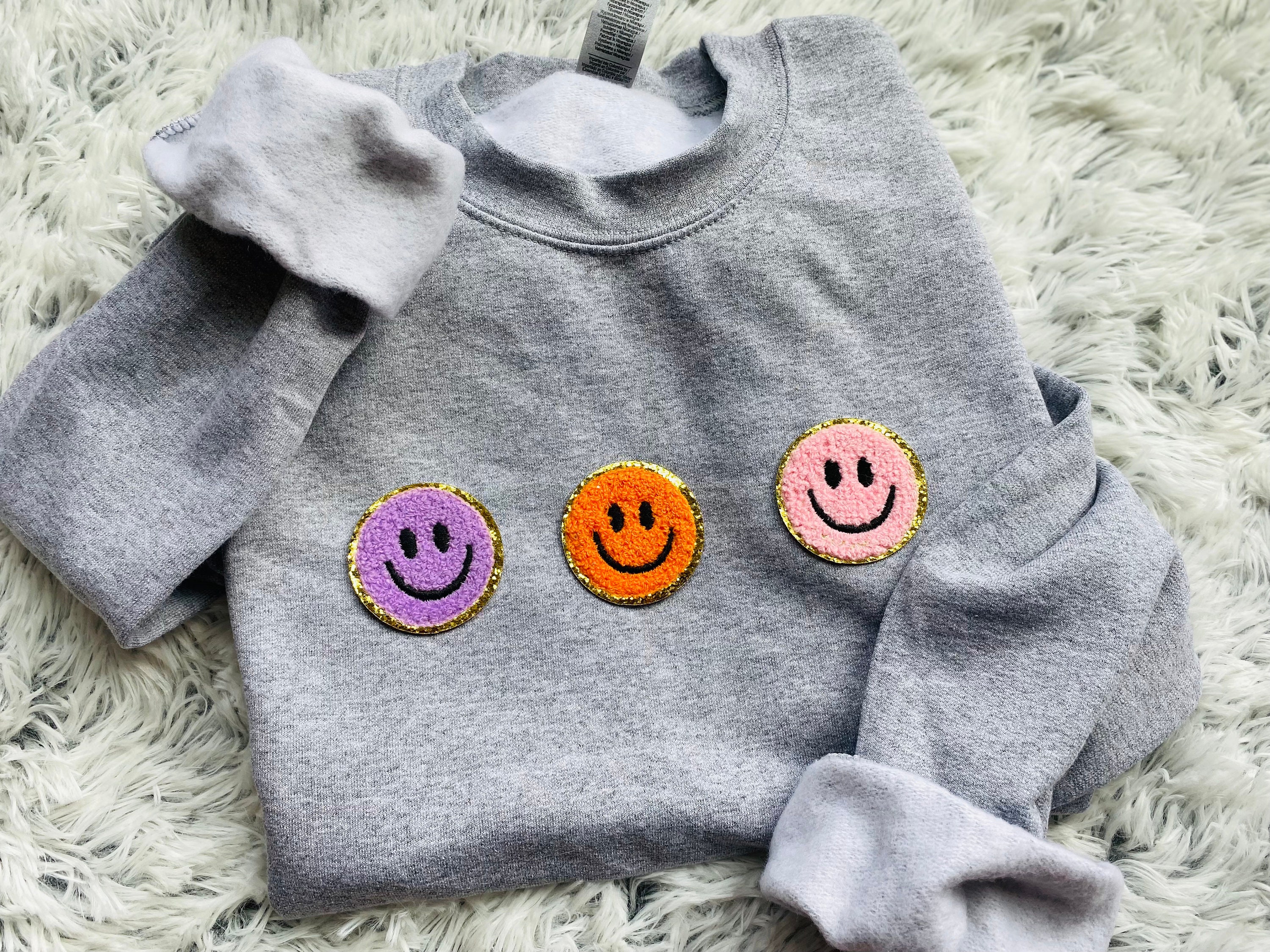 smiley face patch sweatshirt