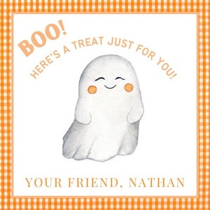 May include: A Halloween-themed card featuring a smiling white ghost with orange cheeks. The card has the text "BOO! HERE'S A TREAT JUST FOR YOU!" and "YOUR FRIEND, NATHAN" in orange text, set against a white background with an orange gingham border.