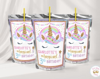 May include: Three silver foil drink pouches with yellow straws, each featuring a unicorn graphic with a gold glitter horn, a pastel rainbow, and the text Charlotte's magical 3rd birthday. The design includes pink bunting and gold stars.