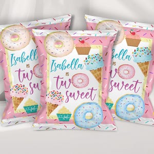 May include: Three pink snack bags featuring a colorful sprinkle pattern, illustrations of donuts, cupcakes, and ice cream cones, with the text "Isabella is two sweet" printed in blue and purple script and block lettering on the front of each bag.