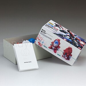 May include: A model kit box with a red and white design, open to reveal contents. The box features images of the assembled model and the text "RZ21". A white instruction booklet is in front of the box.
