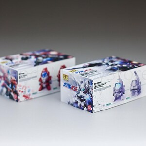 May include: Two white boxes with colorful illustrations of robots. The boxes have Japanese text and images of robot figures. The boxes are on a white surface.