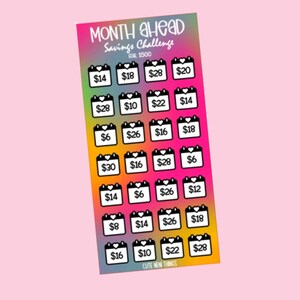 May include: A colorful sticker sheet with a rainbow gradient background. The sheet features 30 black and white calendar stickers with dollar amounts ranging from $6 to $30. The text "MONTH AHEAD Savings Challenge" is at the top of the sheet.