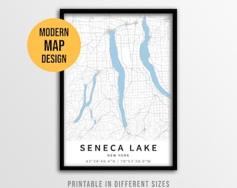 May include: A framed map print of Seneca Lake, New York, featuring light blue water bodies against a white background with grey road networks. The text reads: MODERN MAP DESIGN, INSTANT DOWNLOAD, SENECA LAKE, NEW YORK, 42°38'49.4"N | 76°53'38.0"W.