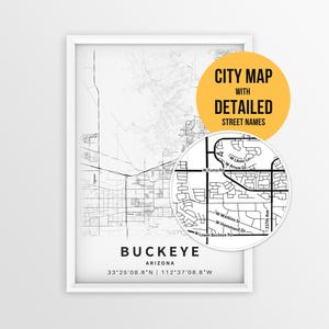 May include: A framed black and white map print of Buckeye, Arizona, featuring geographic coordinates and a circular inset showing detailed street names like W Yuma Rd and W Lower Buckeye Rd. A yellow circle contains the text CITY MAP WITH DETAILED STREET NAMES.