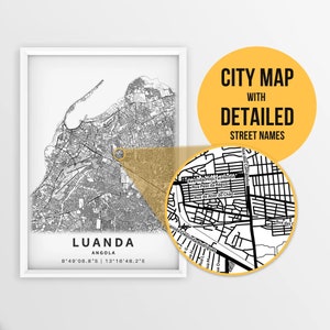 May include: A black and white city map of Luanda, Angola with detailed street names. The map shows the city's layout with roads, streets, and landmarks. The map is framed in a white frame.
