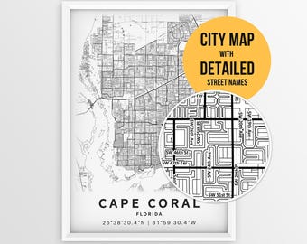 May include: A framed black and white map print of Cape Coral, Florida, featuring detailed street layouts and coordinates. A circular inset highlights specific street names, and a yellow circle contains the text CITY MAP WITH DETAILED STREET NAMES.