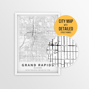 May include: A framed black and white city map of Grand Rapids, Michigan, with detailed street names. The map includes a close-up view highlighting specific streets. The text "CITY MAP WITH DETAILED STREET NAMES" is displayed on a yellow circle.
