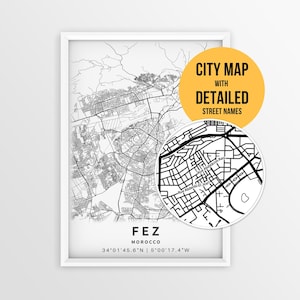 May include: A framed black and white map print of Fez, Morocco, featuring detailed street layouts and coordinates. A circular inset shows a zoomed-in view of specific streets, including Rue Abdelkrim-Rais and Rue Abdenbi El Jirani.
