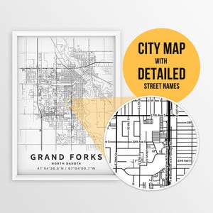 May include: A black and white city map of Grand Forks, North Dakota with detailed street names. The map shows the city's layout with streets, avenues, and landmarks. The map is framed in a white frame.
