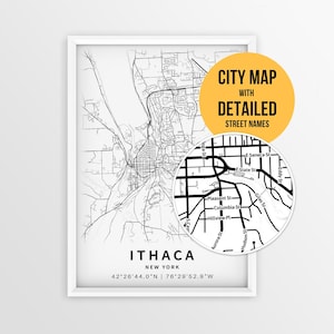 May include: A framed black and white map print of Ithaca, New York, featuring street layouts and coordinates. A circular inset shows a magnified view of street names like E. State St and Columbia St. A yellow circle contains the text CITY MAP WITH DETAILED STREET NAMES.