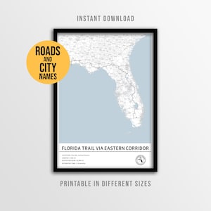 May include: A framed map print of the Florida Trail via Eastern Corridor, with a light blue background and black frame. The print includes the text "Roads and City Names" and "Instant Download". The title "Florida Trail via Eastern Corridor" is displayed at the bottom.