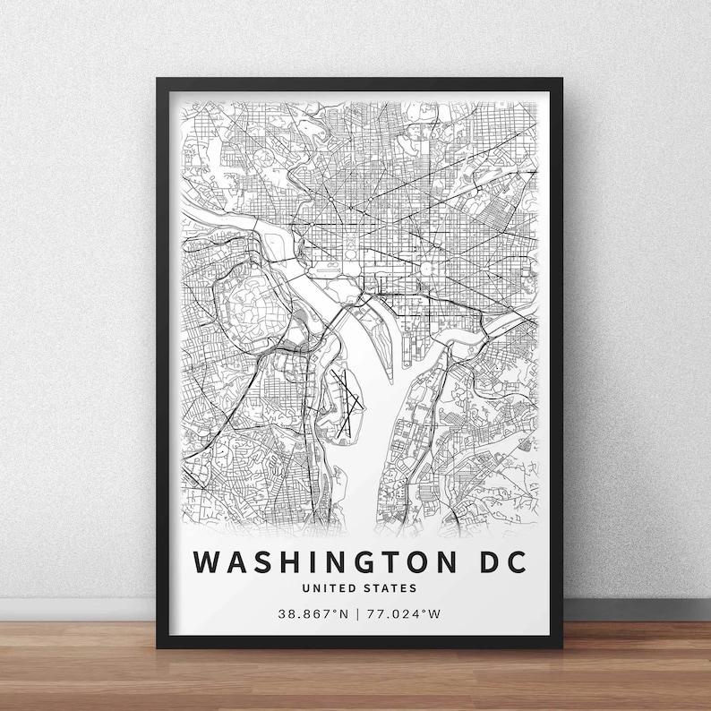 May include: A framed black and white map print of Washington DC, United States. The map details the city's layout, including streets, waterways, and landmarks. The text "WASHINGTON DC UNITED STATES" is displayed at the bottom, along with the coordinates 38.867&deg;N | 77.024&deg;W.