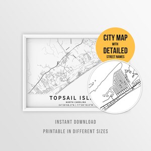 May include: A framed black and white map print of Topsail Island, North Carolina, featuring geographic coordinates and a circular inset showing detailed street names. The text reads CITY MAP WITH DETAILED STREET NAMES, INSTANT DOWNLOAD, PRINTABLE IN DIFFERENT SIZES.