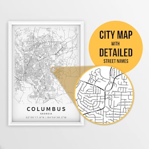 May include: A black and white city map of Columbus, Georgia with detailed street names. The map is framed in a white frame and is set against a white background. The map is highlighted with a yellow circle around the downtown area.