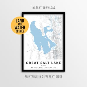 May include: A framed map print of the Great Salt Lake in Utah, with a light blue lake and white land details. The map includes the text "Great Salt Lake Utah" and coordinates. The words "Instant Download" and "Printable in Different Sizes" are also visible.