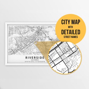May include: A black and white city map of Riverside, California with detailed street names. The map is framed in a white frame and has the coordinates 33°57'01.0"N | 117*23'33.6"W printed below the city name.
