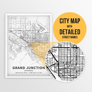 May include: A black and white city map of Grand Junction, Colorado with detailed street names. The map shows the city's layout with streets, avenues, and landmarks. The coordinates for Grand Junction are 39°04'54.9"N 108°33'41.3"W.