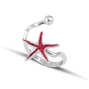 a silver ring with a red starfish on it