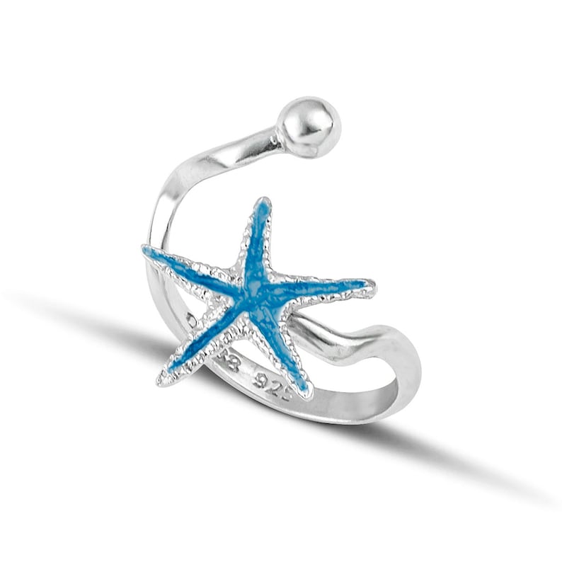 a silver ring with a blue starfish on it