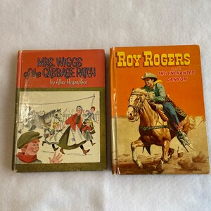 May include: Two vintage children's books. The book on the left is titled "Mrs. Wiggs of the Cabbage Patch" by Alice Hegan Rice. The book on the right is titled "Roy Rogers and the Enchanted Canyon".