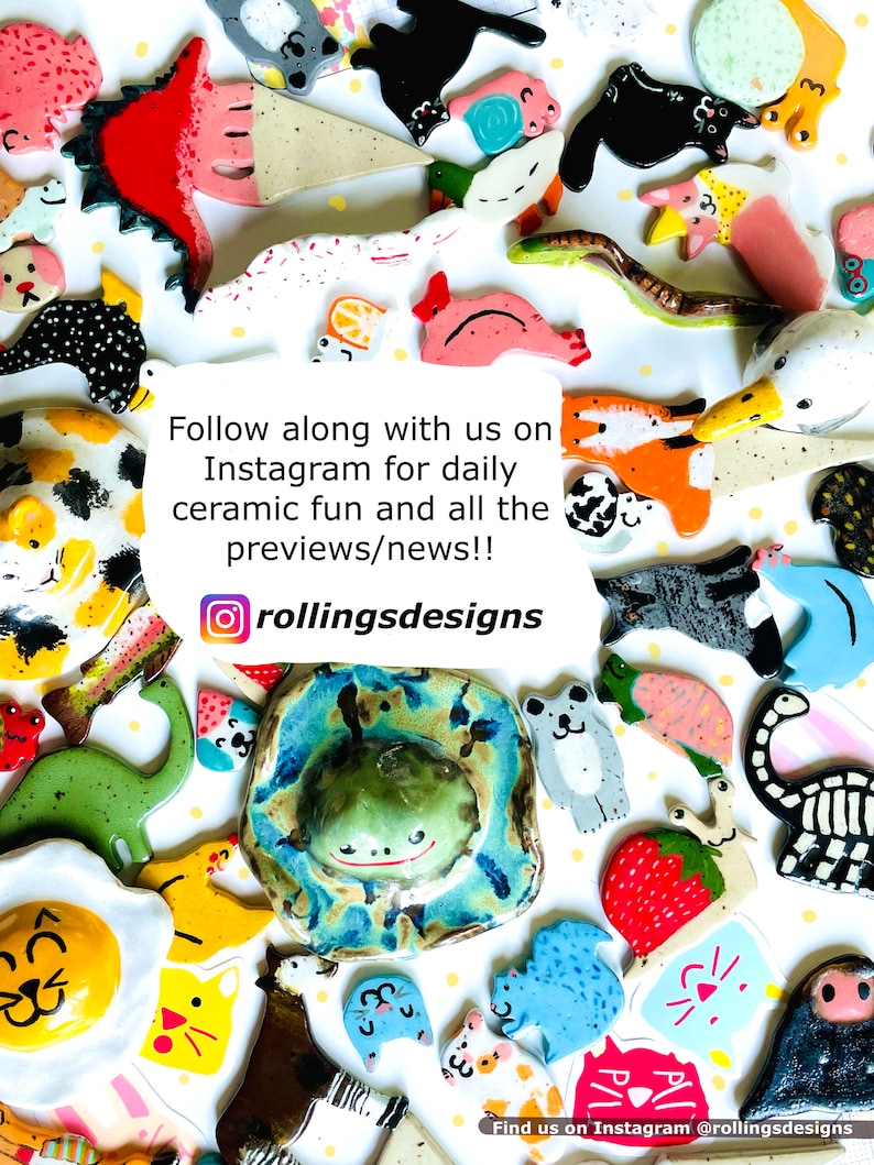 May include: A collection of colorful ceramic figurines, including animals, food items, and abstract shapes. The image includes a frog, a dinosaur, and a strawberry. Text on the image reads "Follow along with us on Instagram for daily ceramic fun and all the previews/news!!" and "rollingsdesigns".