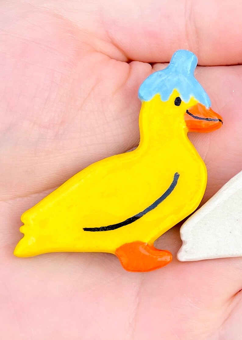 Yellow duck with blie flower on head