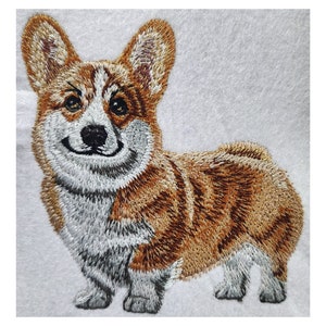 Op de afbeelding: Geborduurde afbeelding van een bruine en witte corgi-hond met een gelukkige uitdrukking. De hond staat op een witte achtergrond.