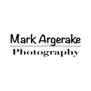 May include: Black and white logo for Mark Argerake Photography. The name is in a handwritten font and the word "Photography" is in a serif font.