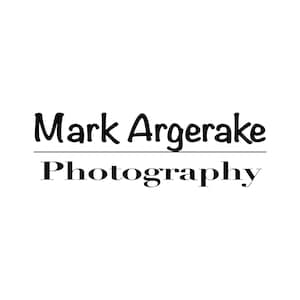 May include: Black and white logo for Mark Argerake Photography. The name is in a handwritten font and the word "Photography" is in a serif font.