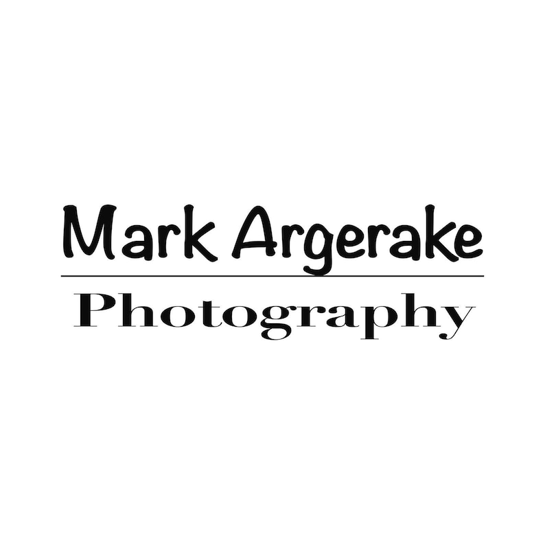 May include: Black and white logo for Mark Argerake Photography. The name is in a handwritten font and the word "Photography" is in a serif font.