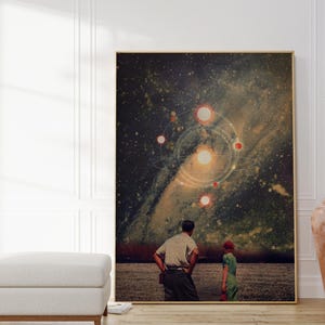 May include: A digital art print featuring a couple standing in a field, looking up at a starry night sky with a galaxy and multiple planets. The print has a vintage aesthetic.