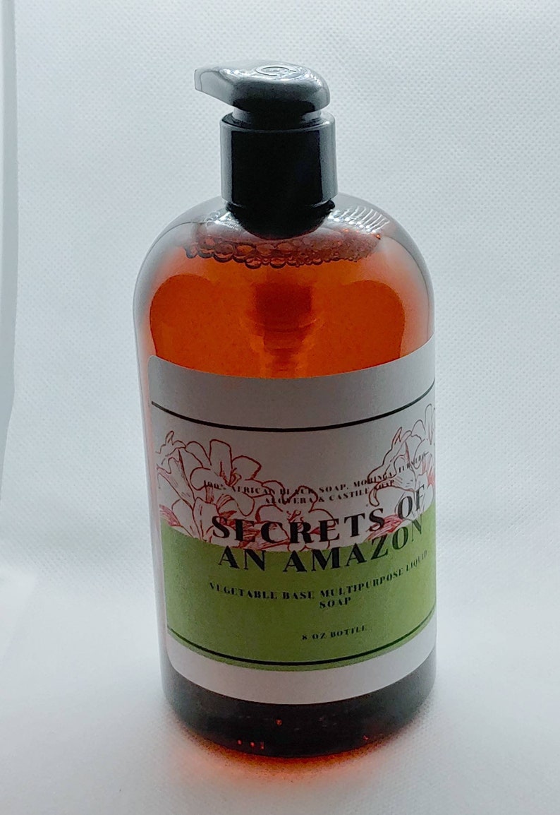 May include: A brown glass bottle with a black pump dispenser. The bottle is labeled "Secrets of An Amazon Vegetable Base Multipurpose Liquid Soap 8 oz Bottle".