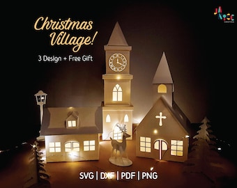 May include: A digital papercraft design of a Christmas village with three buildings, including a church with a clock tower, a house with a snow-covered roof, and a smaller church. The buildings are illuminated with warm white lights and a reindeer stands in front of the church. The text "Christmas Village!" and "3 Design + Free Gift" are displayed above the buildings. The text "SVG | DXF | PDF | PNG" is displayed below the buildings.
