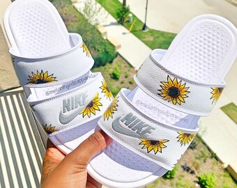 white nike slides with sunflowers